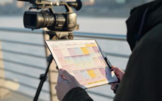 caméraman qui lie le cahier des charges pour faire la vidéo